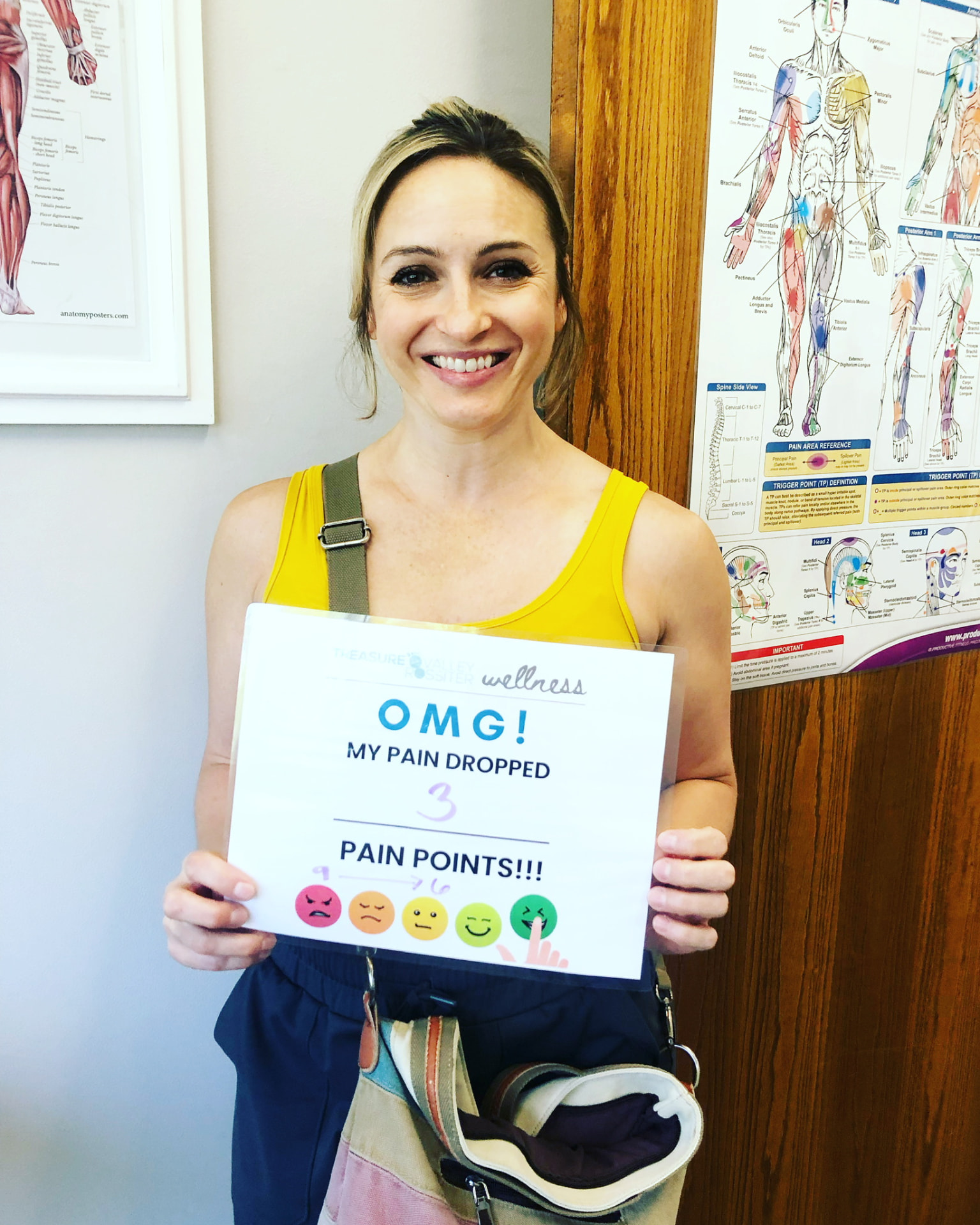 Real Treasure Valley Rossiter client holding a sign showing how much their discomfort dropped after a session (4 of 7)